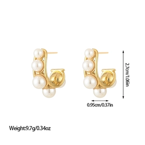 French style gold C-shaped pearl earrings with double loop design on white background