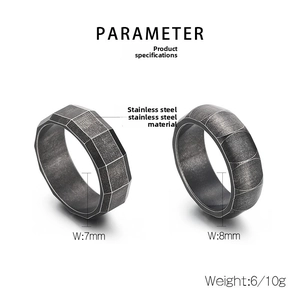 Detail view of faceted and brushed dark grey stainless steel rings with 7mm/8mm width