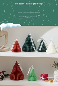 Detailed view of origami Christmas tree candles with best wishes ribbons and pine cones