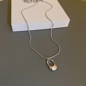 Minimalist silver stainless steel snake chain with hollow oval pendant on box