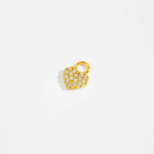 Macro detail of a golden heart pendant with pavé set sparkling cubic zirconia stones