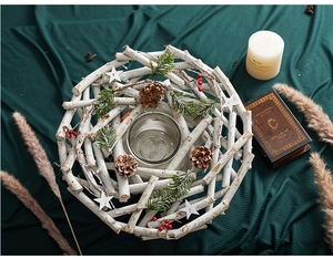 Top view of a rustic white wooden wreath candle holder with pine cones and berries