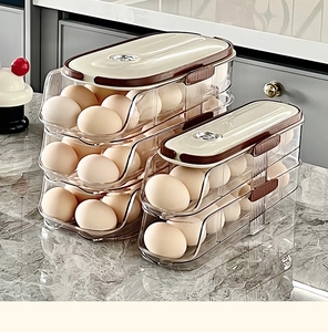 Detail view of multi-layer egg storage boxes on a marble countertop with rolling design