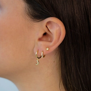 Detail of S925 silver gold-plated evil eye earrings set with star and moon charms