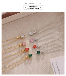 Detail of heart-shaped zircon pendant necklaces in pink, red, green and white colors