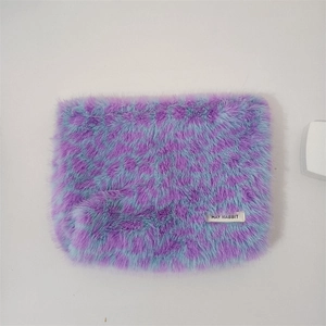 Fashionable leopard print plush makeup bag in purple and blue faux fur with logo label