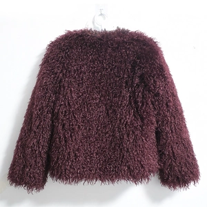 Close-up of deep purple faux fur coat with fluffy texture and round neckline detail