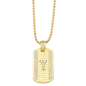 Detailed macro view of golden ball chain necklace with Y-letter zircon military pendant