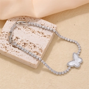 Silver butterfly tennis bracelet with sparkling zircons and mother of pearl on a stone stand