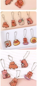Detail of cute acrylic Capybara keychains with various cartoon designs and bead chains