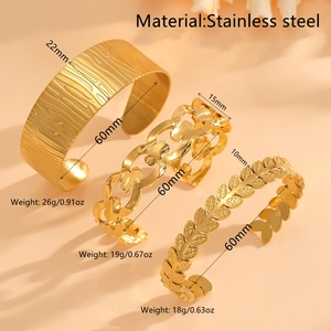 Three gold-plated stainless steel bangles featuring wood grain, heart, and leaf designs