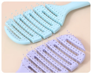 Close-up of vented hair brushes in light blue and purple with rounded massage bristle tips