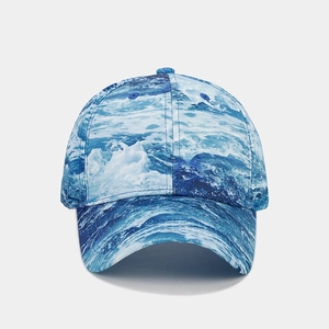 Close-up of blue and white water wave digital print on a cotton canvas baseball cap