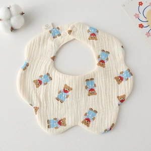 Detail of petal-shaped muslin cotton baby bib with cute cartoon bear pattern