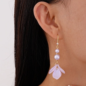 Elegant gold hook earrings with lavender pearls and acrylic petals shown on a model