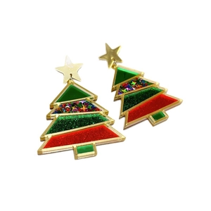 Christmas tree earrings with red bow and colorful sequins on white background