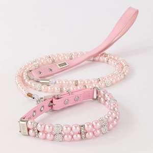 Detailed view of pink double-row pearl pet collar with rhinestone accents and leather strap