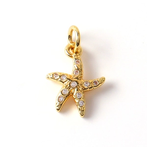 Macro shot of gold-plated starfish pendant set with sparkling zircon micro-inlays