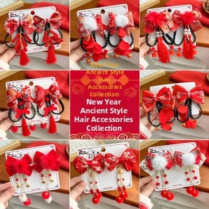 Detail of red festive hair accessories with embroidery tassels and pearls for New Year
