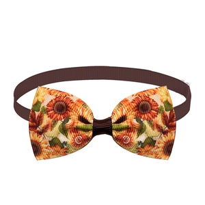 Detailed close-up of sunflower print pet bowtie with brown adjustable ribbed strap