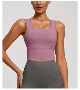 Detailed view of the square neckline and wide shoulder straps on a dusty pink sports bra