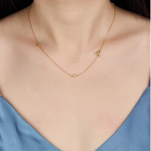 Close-up of golden S925 silver letter A pendant necklace with sparkling zircon details