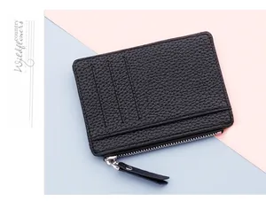 Detail of ultra-slim black litchi pattern leather card holder with secure metal zipper