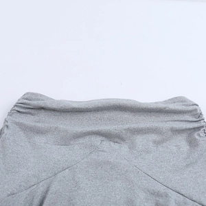 Macro shot of grey knitted fabric texture and detailed gathered ruffle stitching