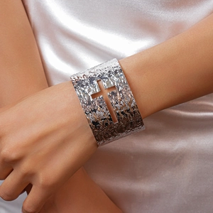 Detail of silver hammered texture cuff bracelet featuring a central cross cutout