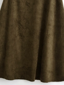 Macro detail of dark olive green faux suede fabric texture showing soft velvet finish