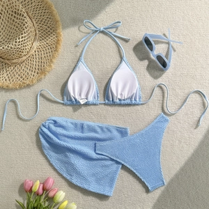 Detailed view of light blue seersucker bikini set with matching textured beach sarong cover-up