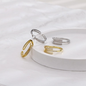 Detail of silver S925 hallmark on a gold geometric knot ring with sparkling zircon stones