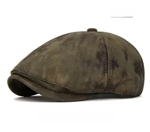 Close-up of vintage olive green newsboy cap with stitching details and top button