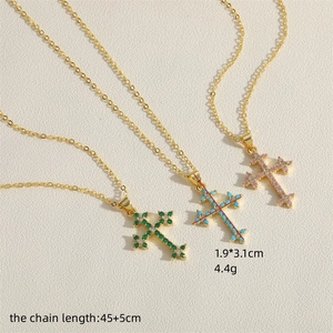 Three gold necklaces with cross pendants featuring green, blue, and purple zircons