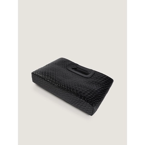 Detail view of black woven texture and oval cutout handle on elegant PU leather clutch