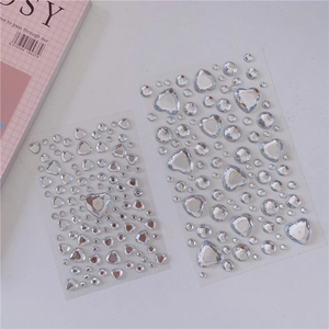 Detail showing acrylic crystal gemstone stickers with heart and round shapes for DIY craft