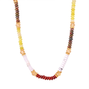 Detail of colorful Bohemian beaded necklace with red, yellow, green beads and gold spacers