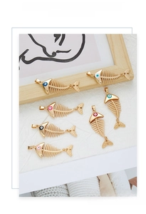 Macro detail of six colorful fishbone alloy pendants with polished gold finish