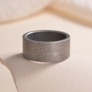 Minimalist 10mm wide matte dark gray titanium steel ring with a vintage finish
