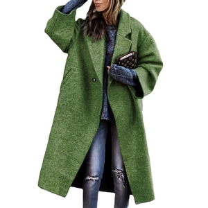 Detail view of green wool coat featuring wide lapels and practical oversized side pockets