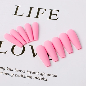 Detail of pink matte coffin press on nails in a professional flat lay arrangement