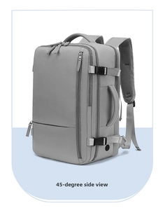 Side view of gray water-resistant travel backpack with side handle and charging port