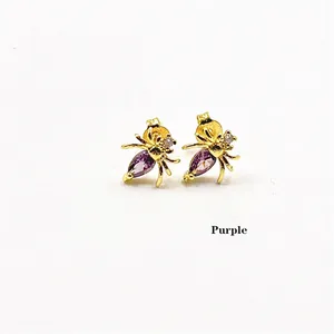 Golden spider stud earrings featuring purple marquise zircon and sparkling accents