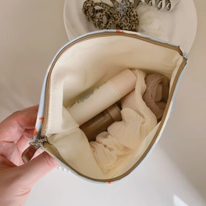 Internal view of blue floral cotton bag showing capacity for lotions and cosmetics
