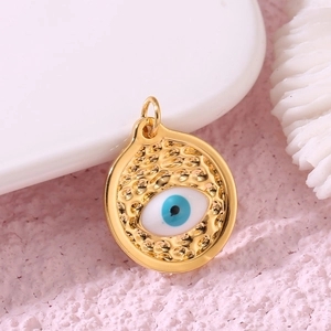 Detailed view of hollow devil eye charm in gold copper with zircon and enamel inlays