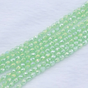 Macro shot of light green faceted glass beads with AB coating for DIY jewelry making