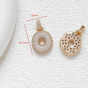 Macro detail of round gold pendant with white zircon micro-pave and dimensions