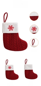 Detailed view of red knit Christmas stocking with white snowflake embroidery and hanging loop