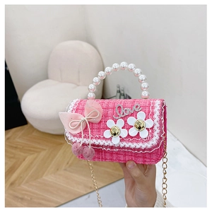 Detail of pink tweed bag for girls with pearl handle, mesh bow and Love rhinestones