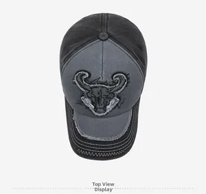 Top view of distressed washed cotton baseball cap with bull skull embroidery detail